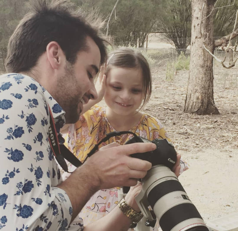 Showing a child the back of the camera, on a community day