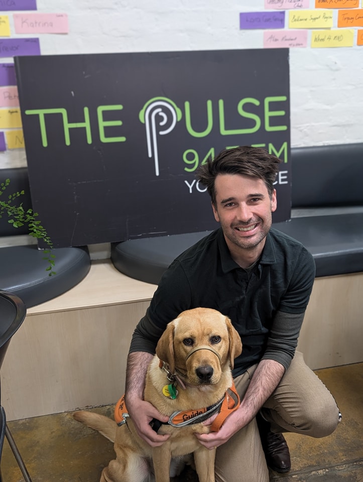 With a guide dog in training at The Pulse 94.7 FM Geelong
